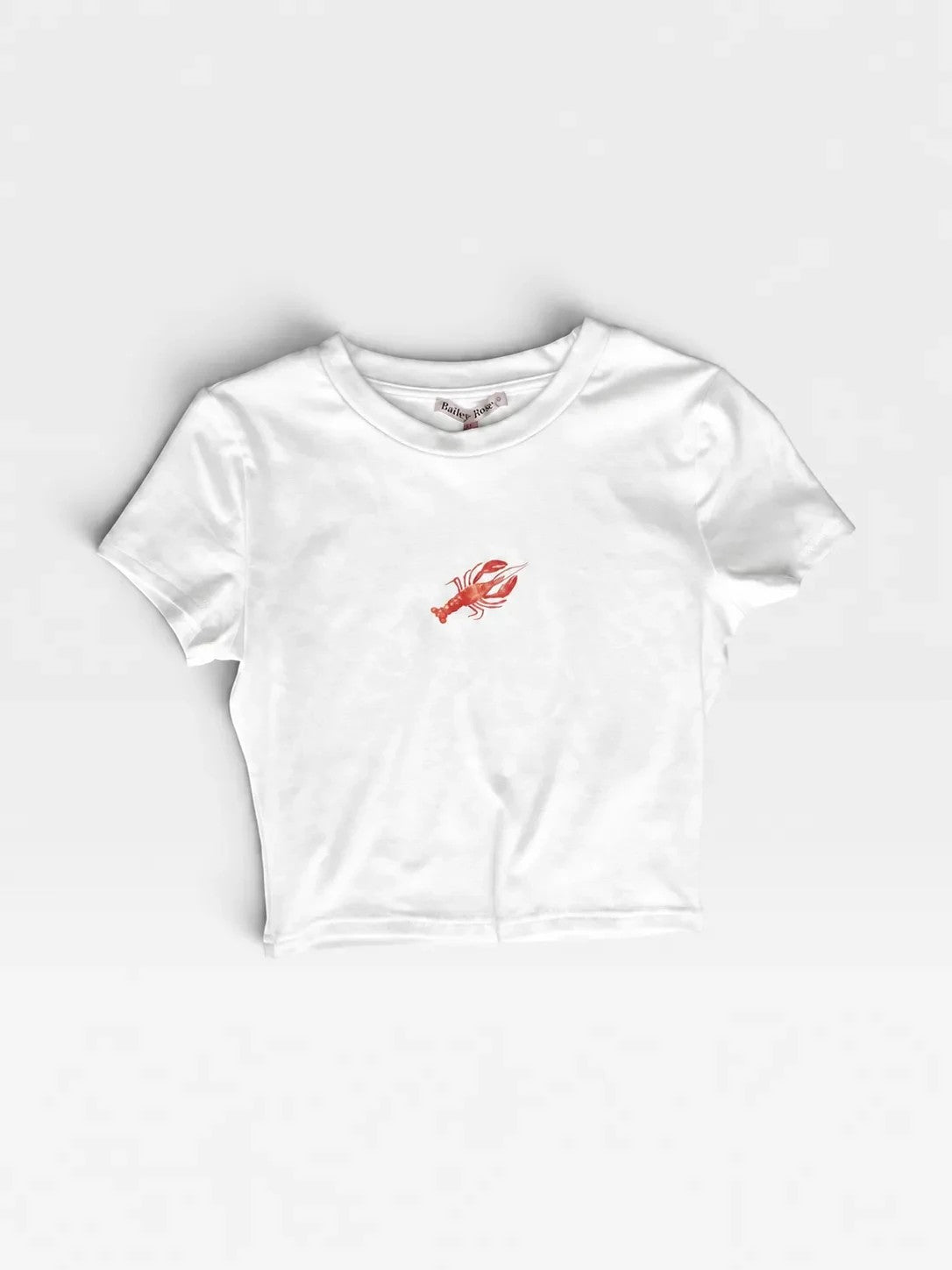 TheConsignmentBar white Bailey Rose crop t-shirt featuring a small red crawfish graphic on the chest