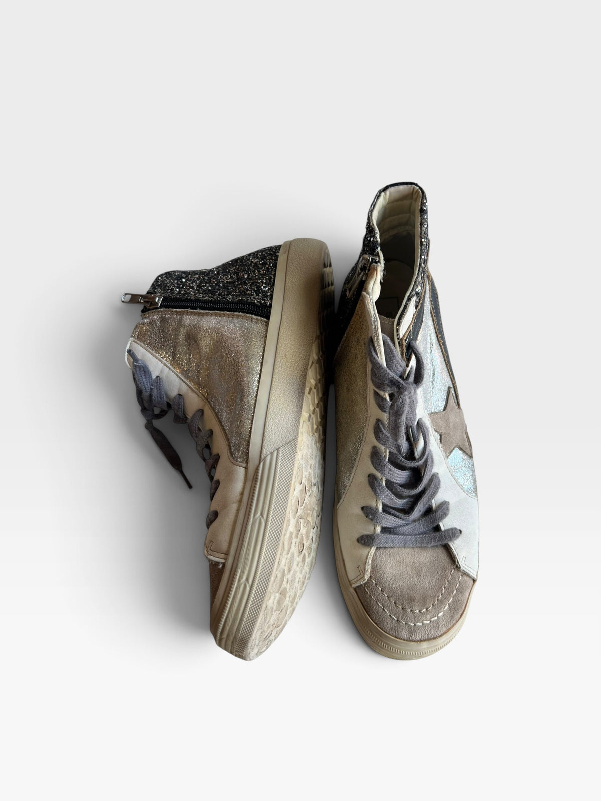 TheConsignmentBar SHU SHOP high top sneakers in silver and black with glitter accents, suede details, and side zippers.
