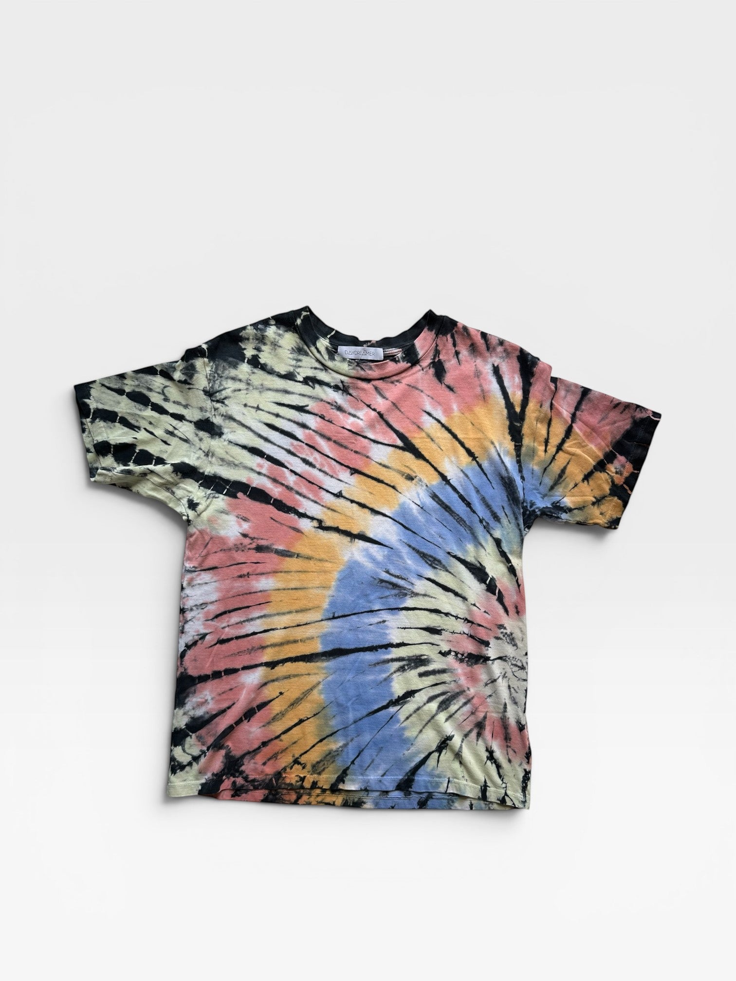 TheConsignmentBar daydreamer tie dye t-shirt in a vibrant multi-color spiral pattern on a soft cotton fabric