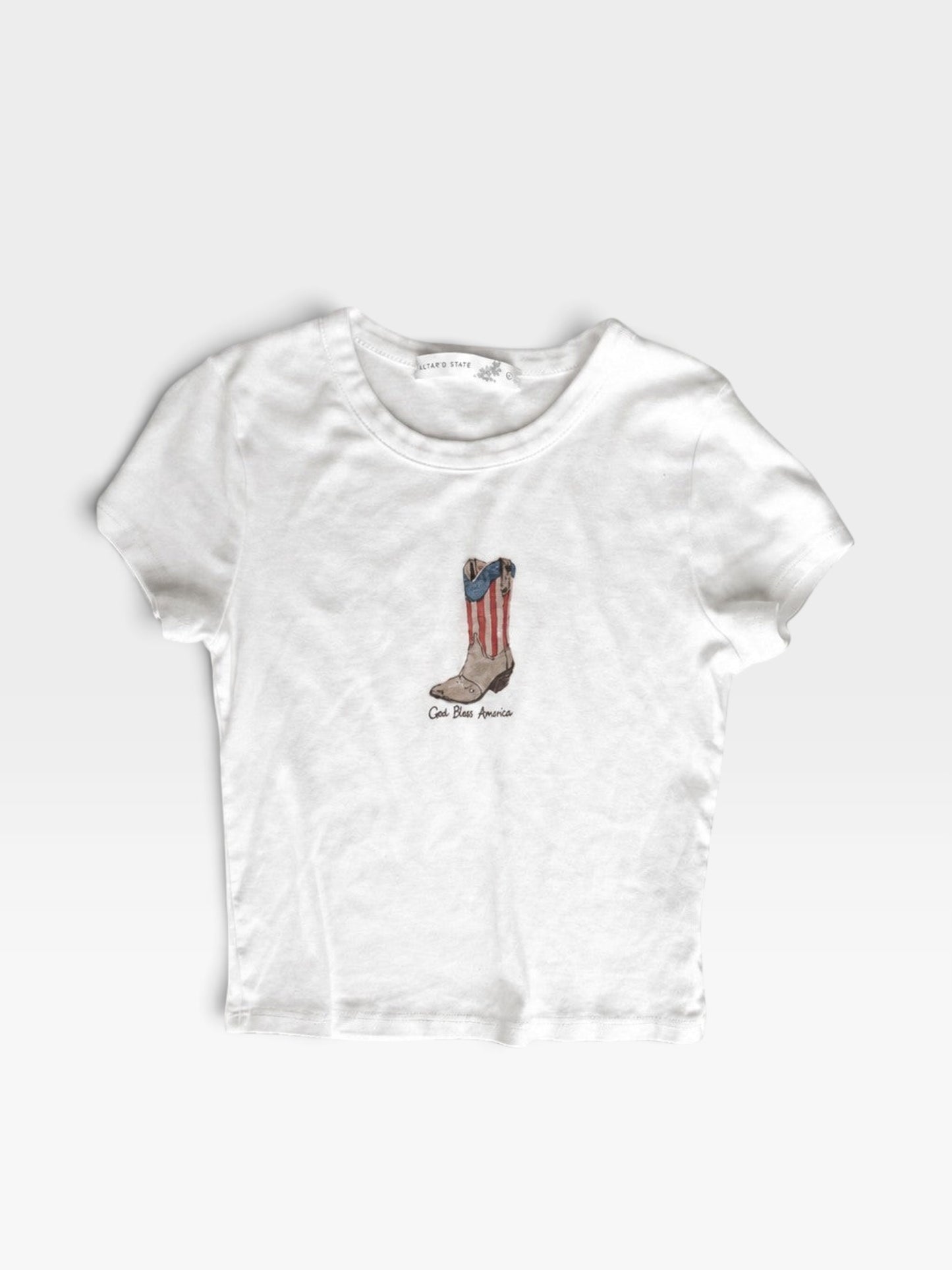 TheConsignmentBar white Altard State t-shirt featuring a graphic of a cowboy boot with American flag stripes
