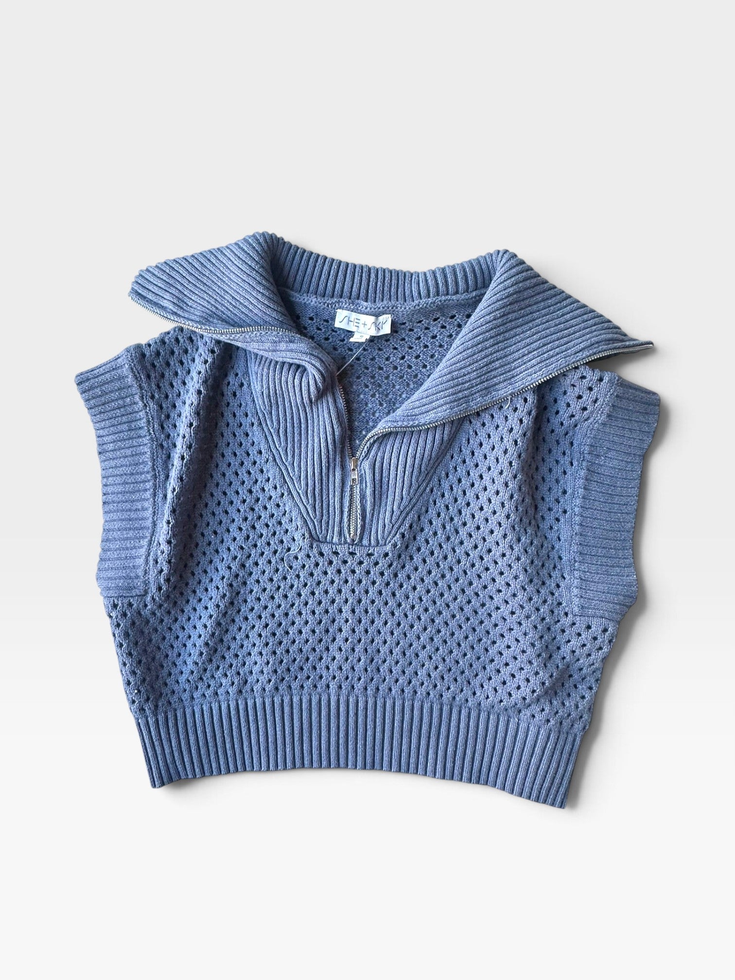 TheConsignmentBar blue She & Sky knit vest with a quarter-zip collar, ribbed hem, and open crochet-style texture.