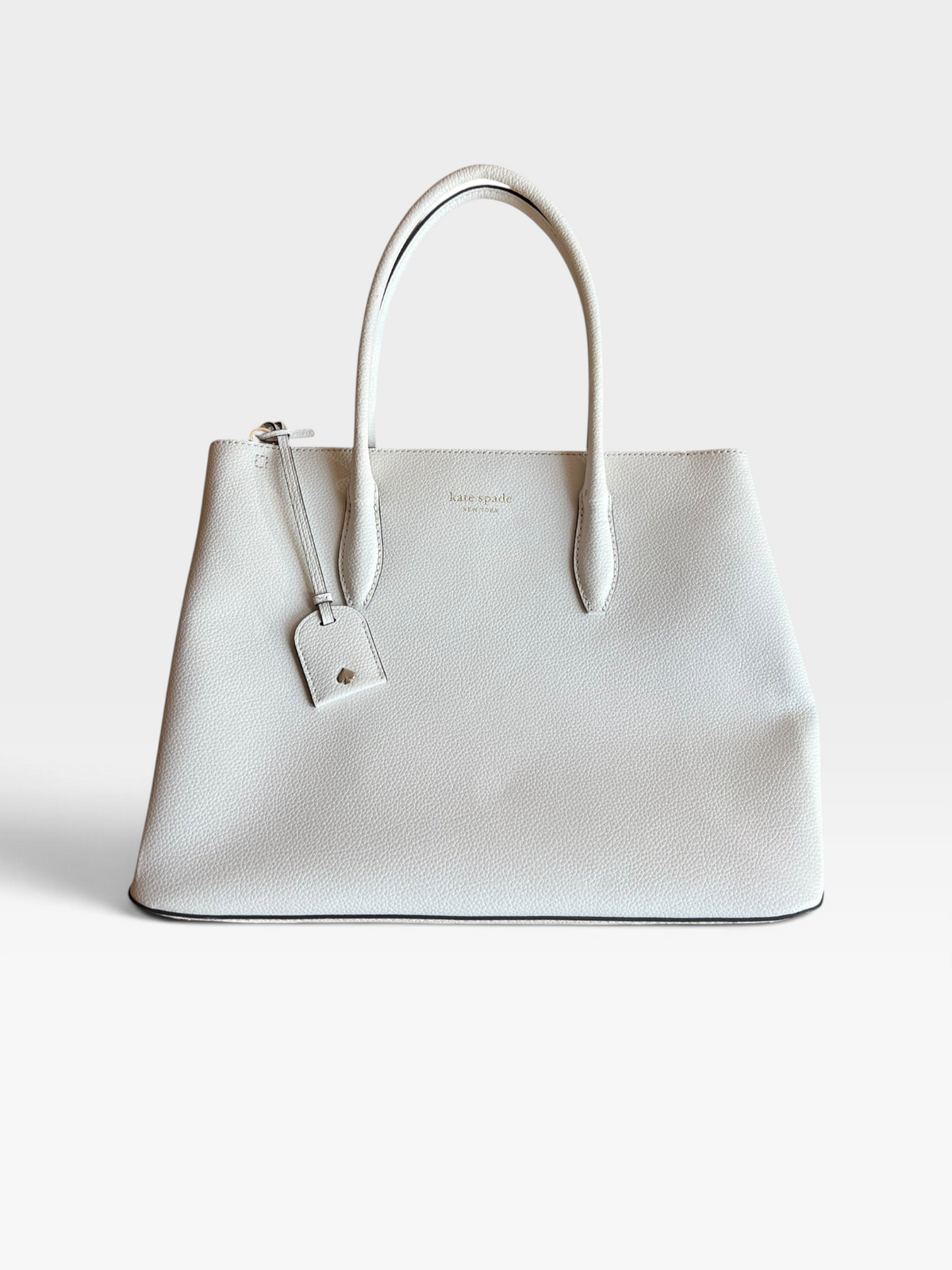 TheConsignmentBar Kate Spade white pebbled leather tote bag with top handles and a matching luggage tag
