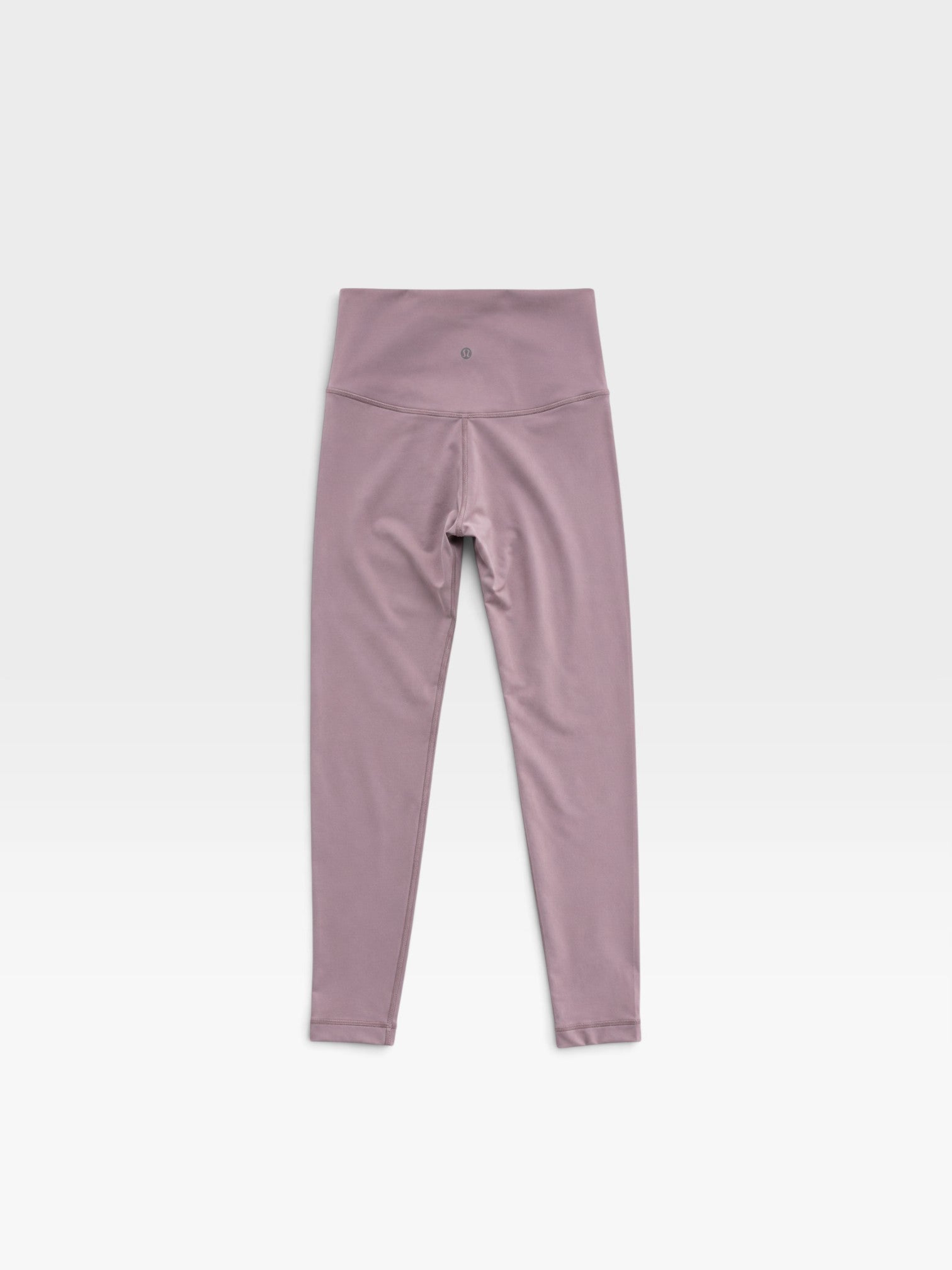 TheConsignmentBar Lululemon high-rise leggings in a muted pink shade, size 4, featuring a smooth athletic fabric.