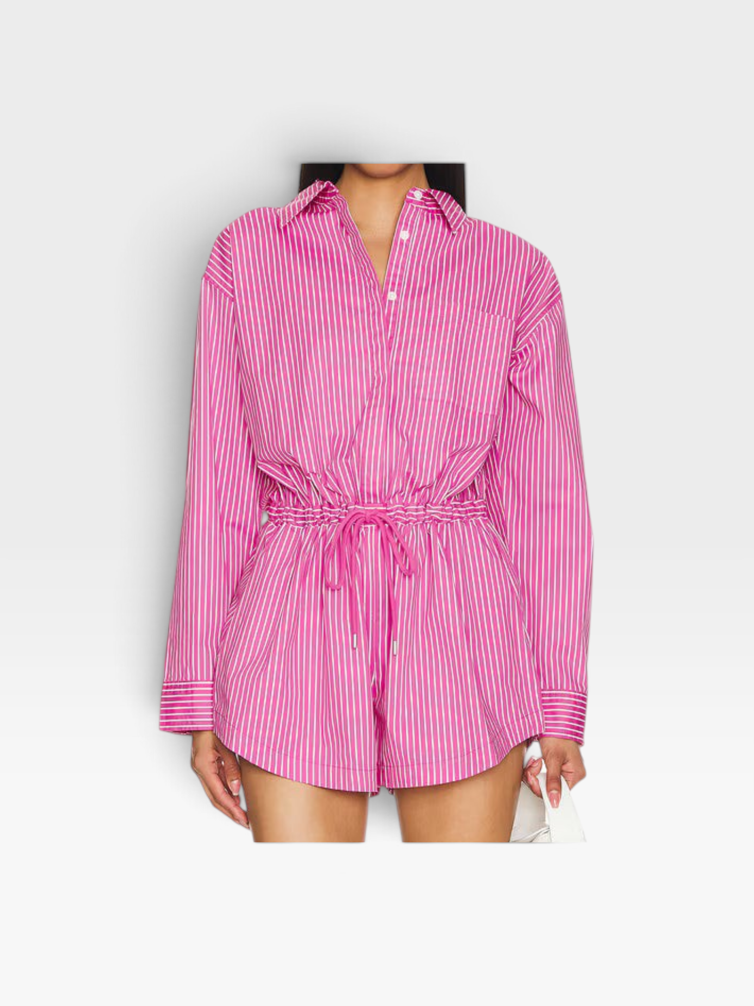 Model wearing a pink and white striped long-sleeve button-down romper by TheConsignmentBar with a drawstring waist.