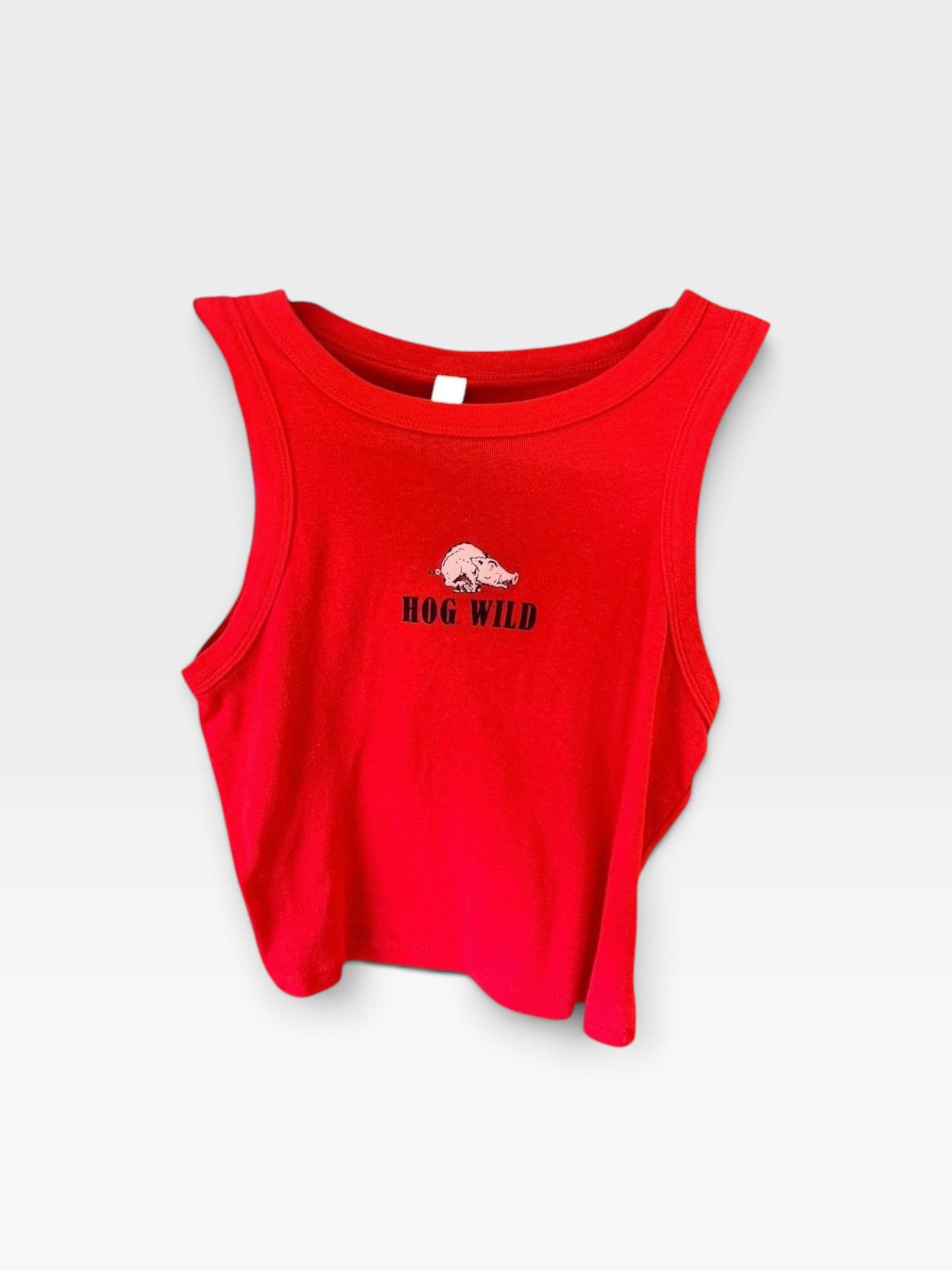 TheConsignmentBar red BELLA + CANVAS tank top featuring a small hog graphic and Hog Wild text on the chest.